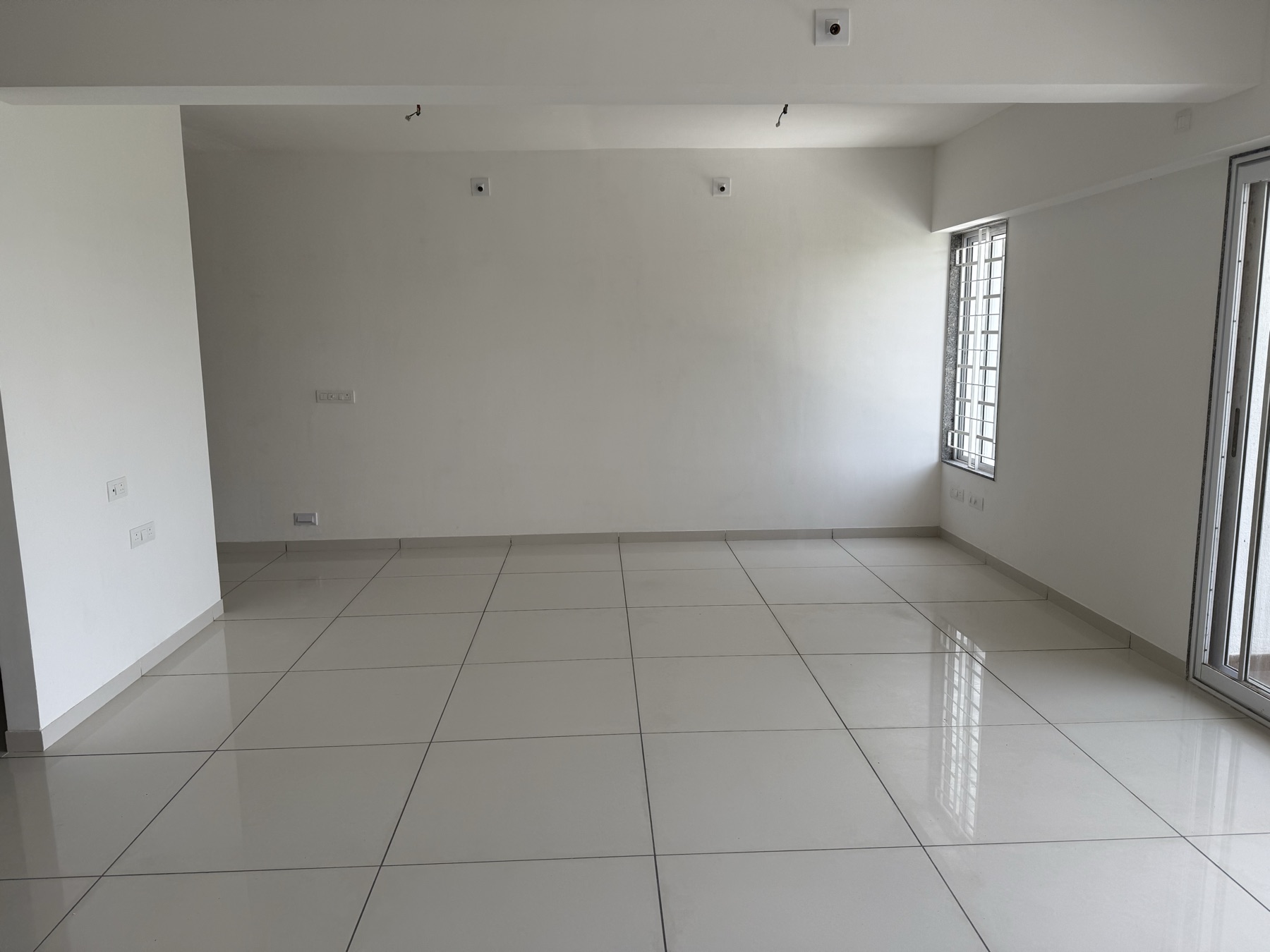 Light-filled living room with vitrified tile flooring