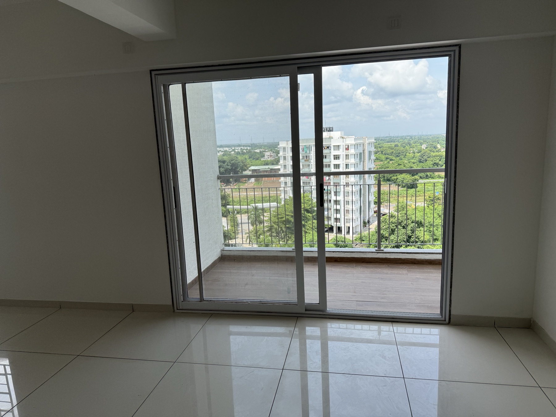 Dining area with sliding doors to the balcony and open green views